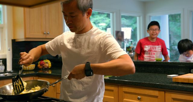 Father Cooking Breakfast at Home While Children Watch - Download Free Stock Images Pikwizard.com