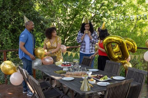 Friends Celebrating 30th Birthday Outdoors with Cake and Decorations