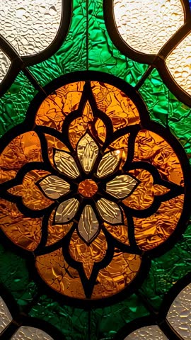 Vertical video revealing amber medallion in textured stained glass quatrefoil with leadwork