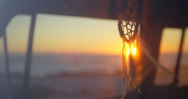 Sunset Through Golden Dreamcatcher Hanging in Window at Sunset - Download Free Stock Images Pikwizard.com