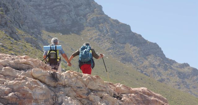 Senior Couple Hiking in Mountainous Terrain on Sunny Day - Download Free Stock Images Pikwizard.com