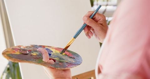 Artist crafting colorful painting on canvas