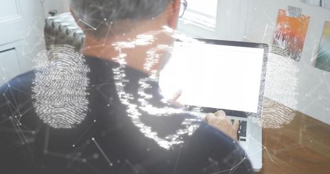 Middle-Aged Man Emphasizing Cybersecurity Measures at Home Desk