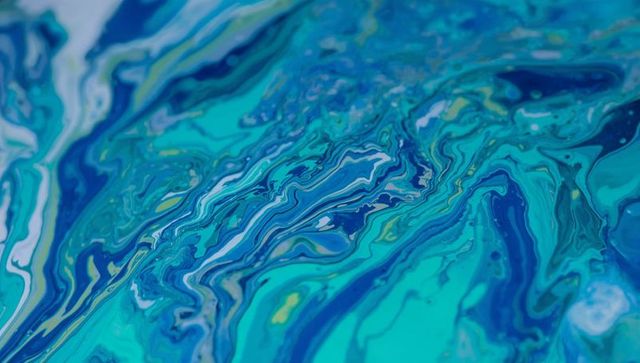 Vibrant blue and teal acrylic fluid art texture