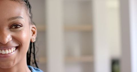 Close-Up of Smiling Woman with Braided Hair Indoors