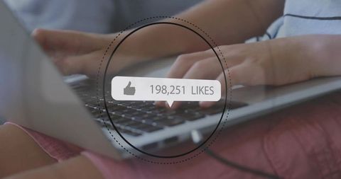 Person Using Laptop with Digital Likes Overlay on Screen