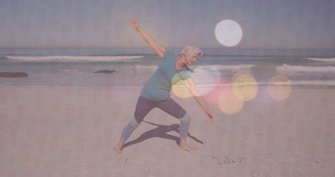 Senior Woman Practicing Yoga on Serene Beach at Sunset