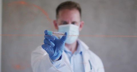 Researcher Holding Vaccine Vial in Advanced Laboratory Setting