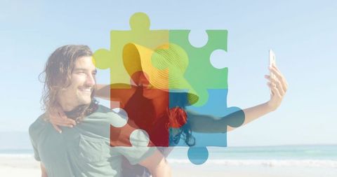 Couple taking beach selfie with piggyback ride and multicolor jigsaw puzzle overlay