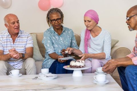 Senior Group Celebrating with Cake in Cozy Indoor Setting