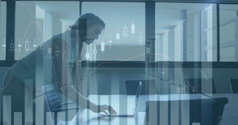 Businesswoman Analyzing Financial Data on Laptop in Office