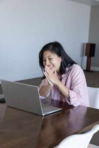 Cheerful Woman Engaged in Productive Remote Work at Home