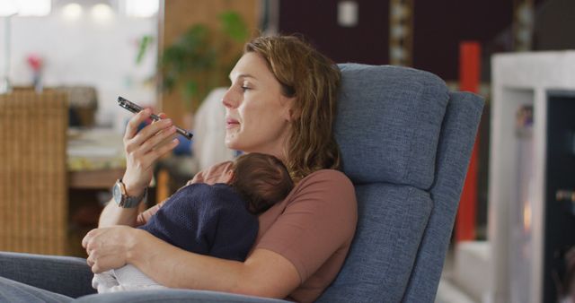 New Mother Relaxing at Home with Infant in Armchair - Download Free Stock Images Pikwizard.com