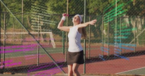 Female athlete serving tennis ball with digital overlays on court