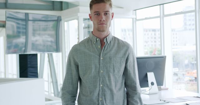 Confident Young Adult Male Posing in Modern Office Setting - Download Free Stock Images Pikwizard.com