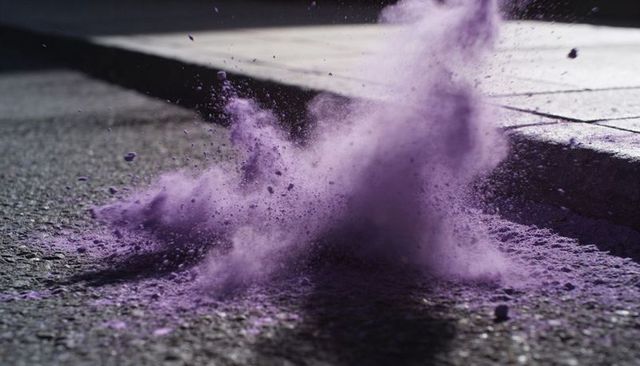 Erupting purple powder cloud over asphalt curb casting dramatic shadow