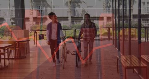 Two modern friends walking bikes on urban campus walkway