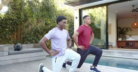 Men exercising outdoors in modern backyard setting