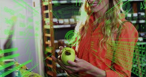 Woman holding green apple and scanning produce with augmented reality hud in grocery