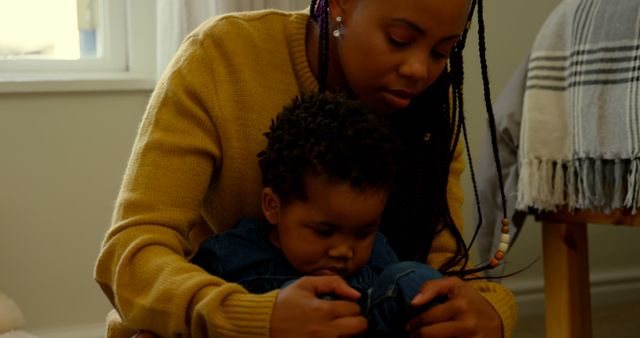 Mother Dressing Her Toddler in Denim Overalls at Home - Download Free Stock Images Pikwizard.com