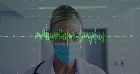 Masked Healthcare Professional Analyzing Digital Data