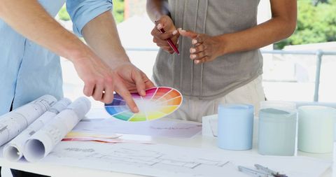 Designers Collaborating Over Color Schemes and Blueprints