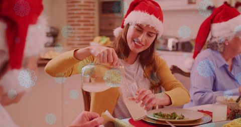 Family Enjoying Christmas Dinner with Festive Snowfall Effects