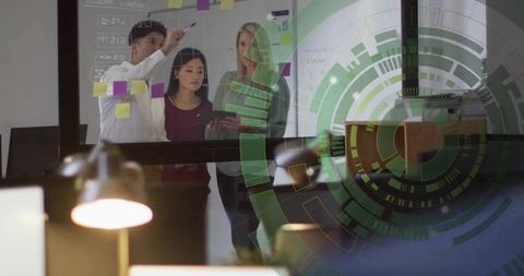 Team Brainstorming on Glass Board with Sticky Notes and Tablet, Planning and Collaboration