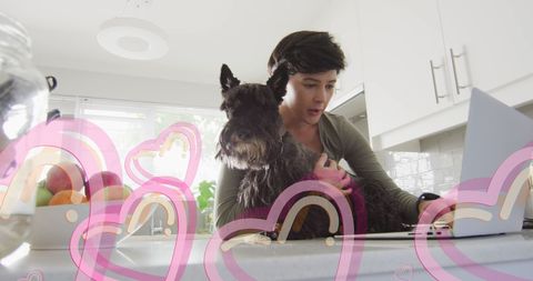 Woman Working on Laptop with Dog and Heart Graphics