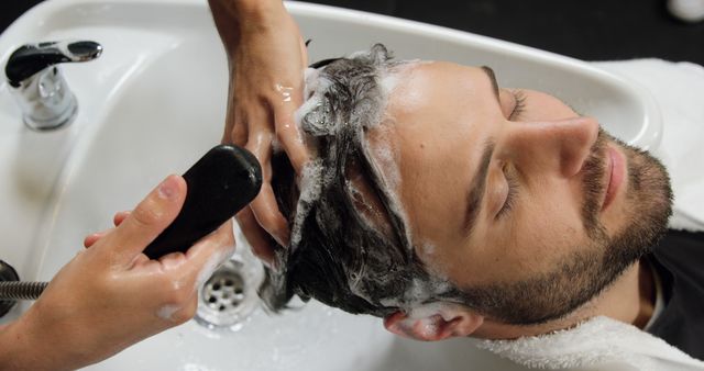 Man Enjoying Hair Wash at Salon by Professional Hairdresser - Download Free Stock Images Pikwizard.com