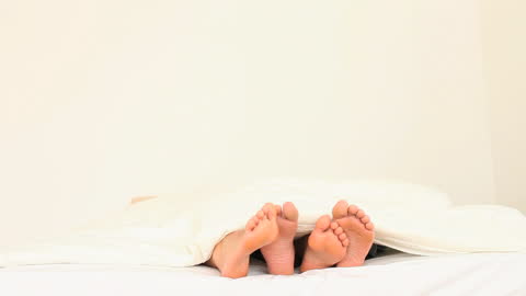 Relaxed Couple Waking Up Under Cozy Blanket