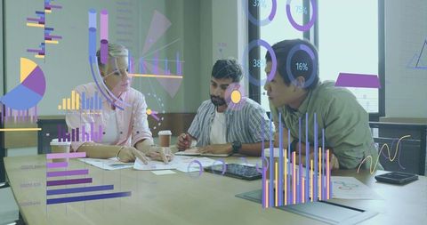 Colleagues analyzing data with interactive charts in modern office setting