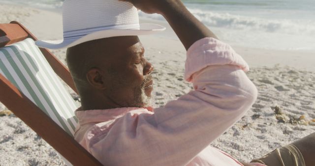 Relaxed Senior Man Enjoying Sun at Beach in Lounge Chair - Download Free Stock Images Pikwizard.com