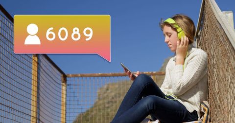 Young woman listening to music celebrating followers milestone