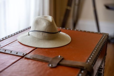 Traveler's safari hat on vintage leather trunk