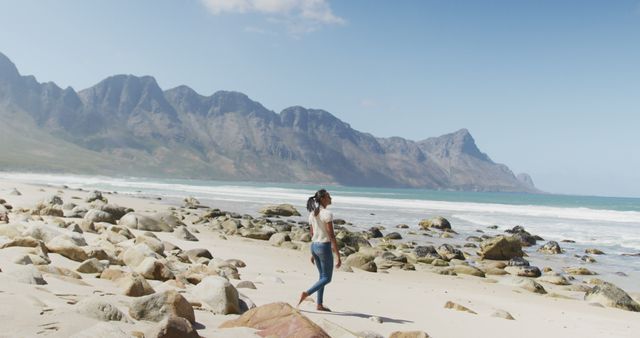 Young Woman Walking on Rocky Beach Enjoying Mountain View - Download Free Stock Images Pikwizard.com