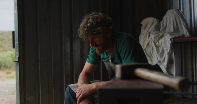 Pensive Craftsman Resting in Workshop - Download Free Stock Images Pikwizard.com