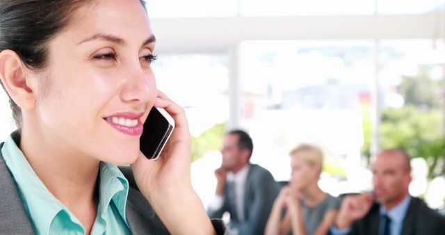 Young Asian Businesswoman on Phone with Diverse Colleagues in Busy Office - Download Free Stock Images Pikwizard.com