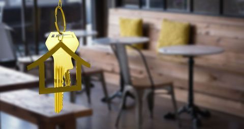 Hanging gold house keys in modern cafe environment