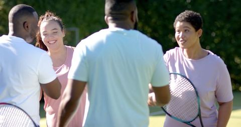 Diverse Friends Celebrating After Tennis Match