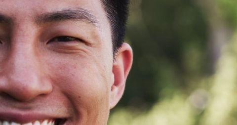 Smiling Asian Male with Blurred Nature Background Outdoors