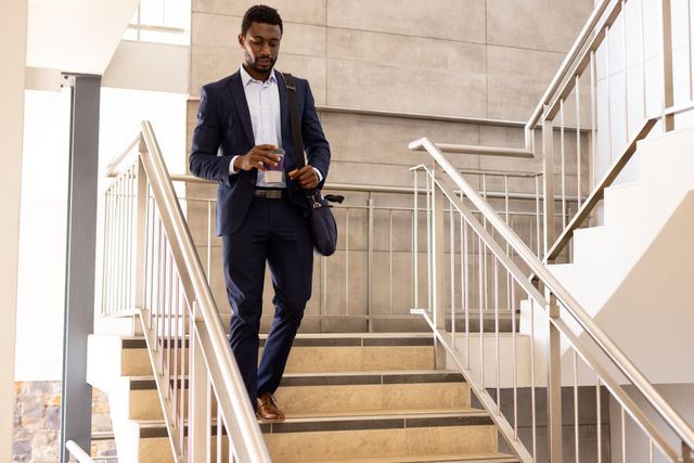 Businessman Walking Downstairs Using Smartphone - Download Free Stock Images Pikwizard.com