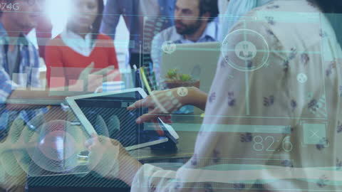 Business Team in Office Analyzing Digital Data on Tablet