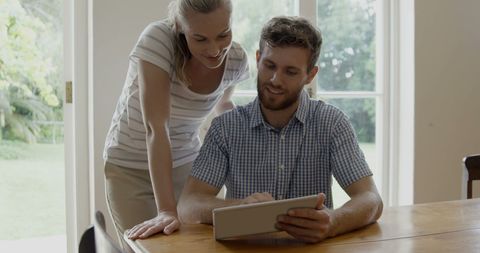 Couple Collaborating on Tablet in Modern Kitchen Setting - Download Free Stock Images Pikwizard.com