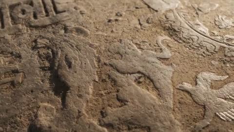 Sliding Reveal of Weathered Stone Relief with Bird Motifs and Emblem for Archaeology Study