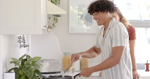 Smiling Couple Preparing Meal in Bright Modern Kitchen