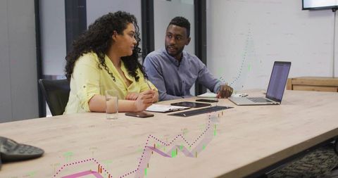 Colleagues Analyzing Economic Trends in Meeting Room