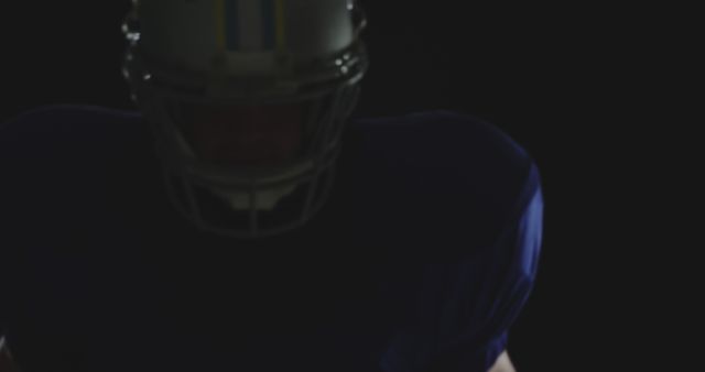 American Football Player Wearing Helmet in Dark Room - Download Free Stock Images Pikwizard.com