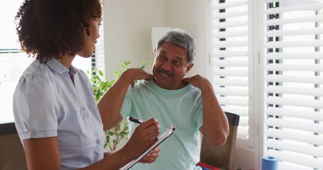 Healthcare professional consulting elderly patient at home - Download Free Stock Images Pikwizard.com