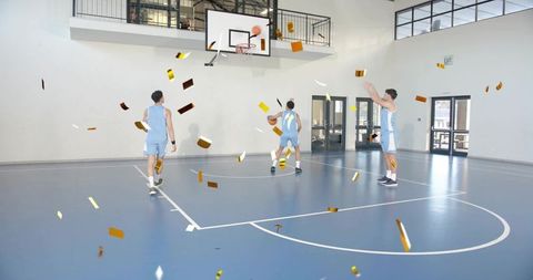 Basketball players shooting and practicing on indoor court with hoop and confetti